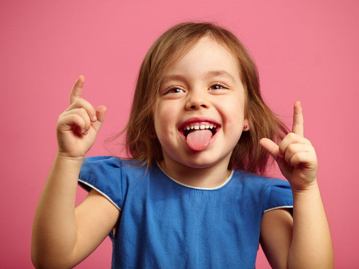 Girl sticking out her tongue and pointing upward
