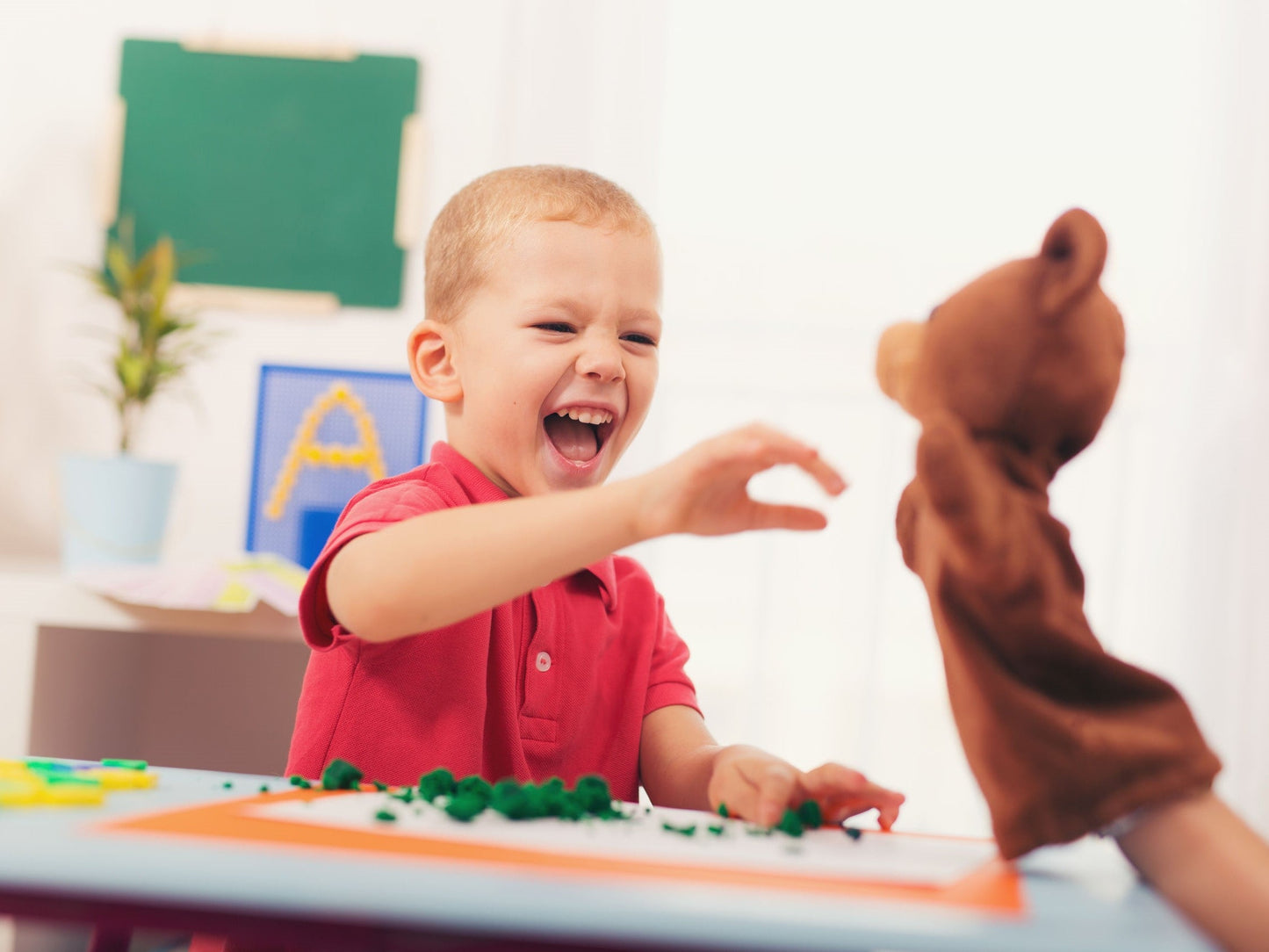 Boy playing with a hand puppet