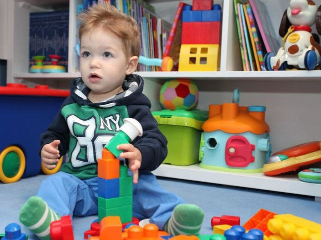 Child sitting on the floor with toys