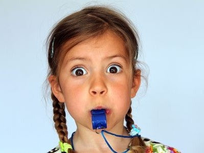 Girl blowing a whistle