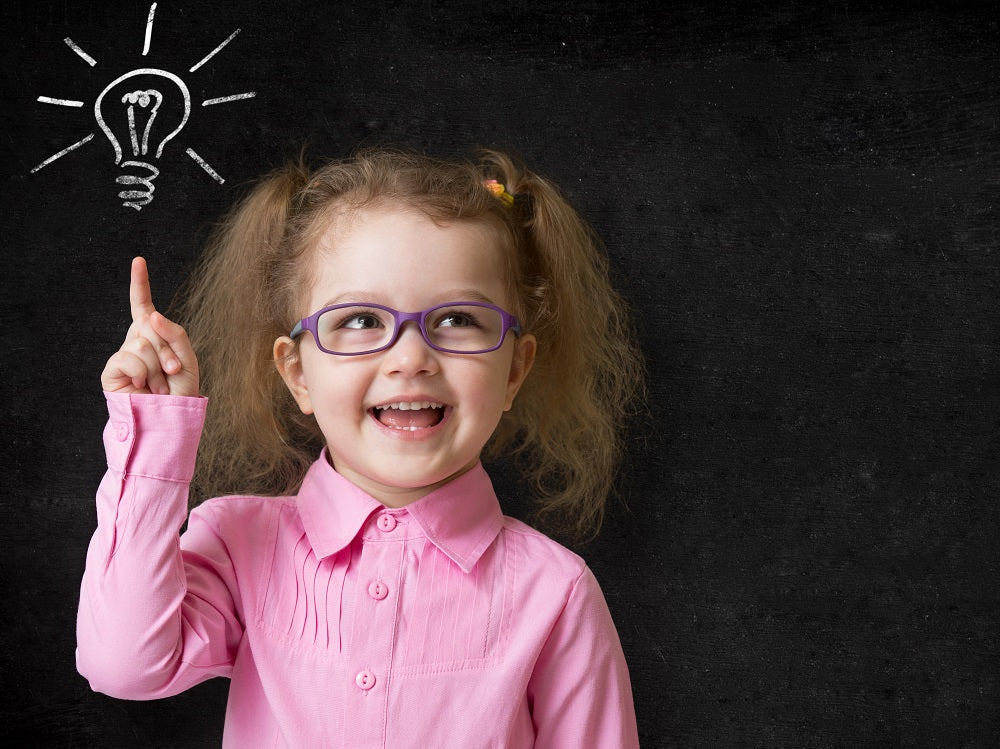 Girl pointing at a light bulb idea on a chalkboard