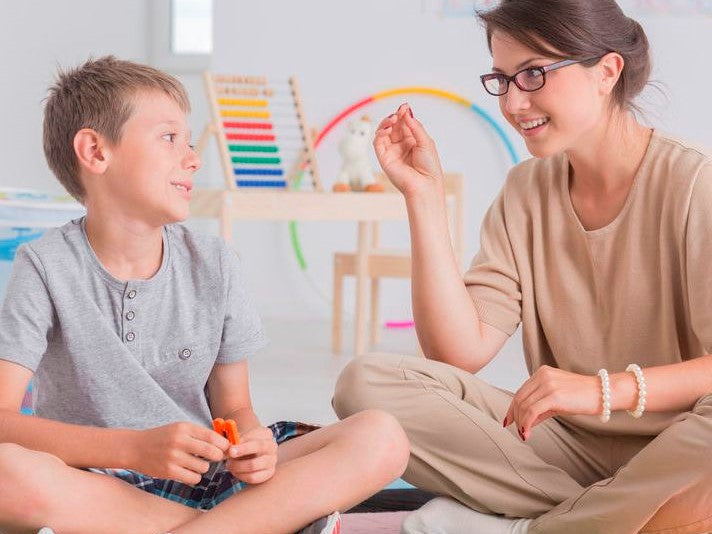 Therapist using a pause gesture with a child