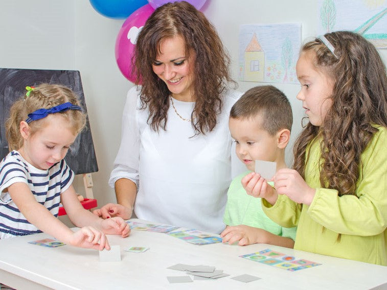 Teacher and children working together at a table