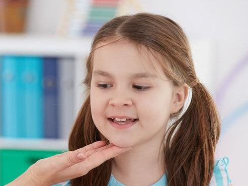 Girl touching the front of her throat