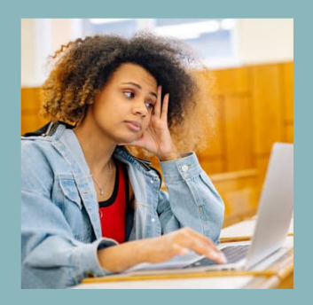 Woman resting her head while working at a laptop